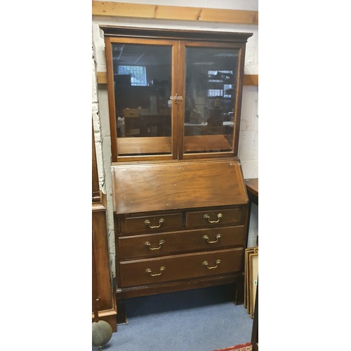 322 - A mid 20th century mahogany bureau bookcase, by Gordon Russell, with glazed top over fall front, two... 