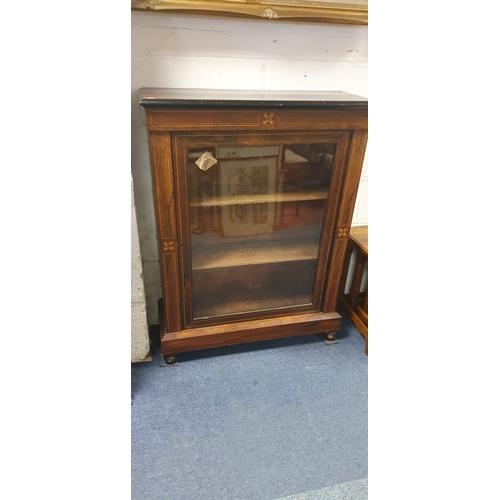 323 - A Victorian rosewood and inlaid pier cabinet, with glazed door enclosing lined shelves, on short fee... 