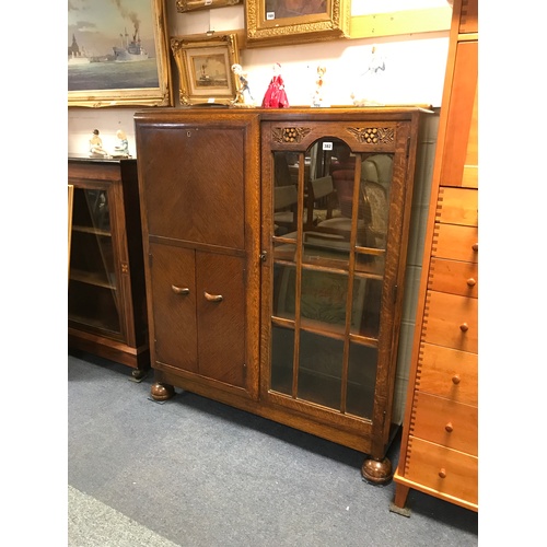 325 - A 1930's oak side-by-side bureau/display, 
with fall front over cupboard doors beside glazed cabinet... 