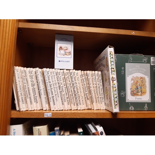 210 - A quantity of Beatrix Potter books, photograph frames etc -