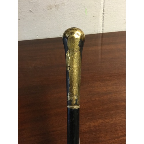 226 - An early 20th century Middle Eastern walking stick, the handle decorated with figures in the desert ... 