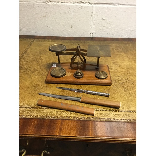 299 - A set of postal scales and weights, together with two letter openers -