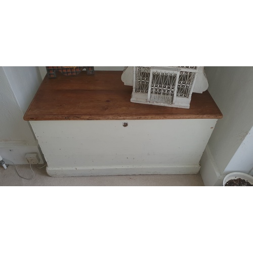 327 - A pine trunk, the lift top enclosing candle box, with waxed top and painted body -