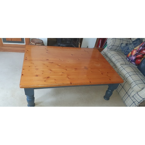 337 - A modern pine coffee table, with painted legs -