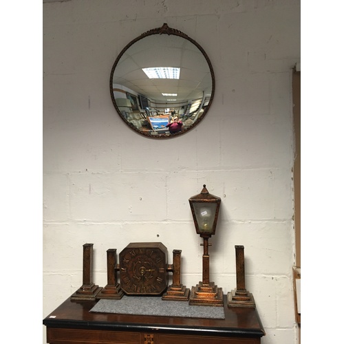 339 - A copper faced clock garniture (no movement), together with a similar lamp designed as a street lamp... 