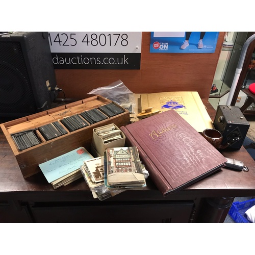 303 - A mixed lot, to include cigarette cards, stamps, glass plates, postcards, camera etc -