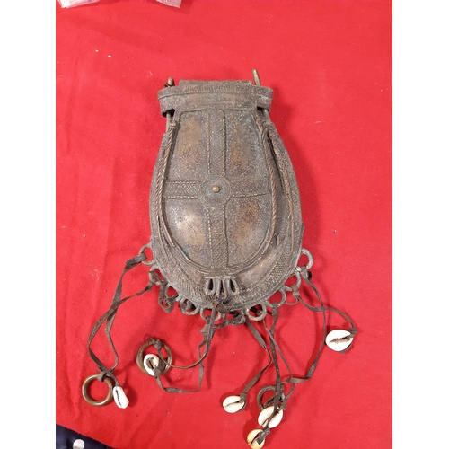224 - An antique West African metal tobacco or medicine pouch also used as currency -