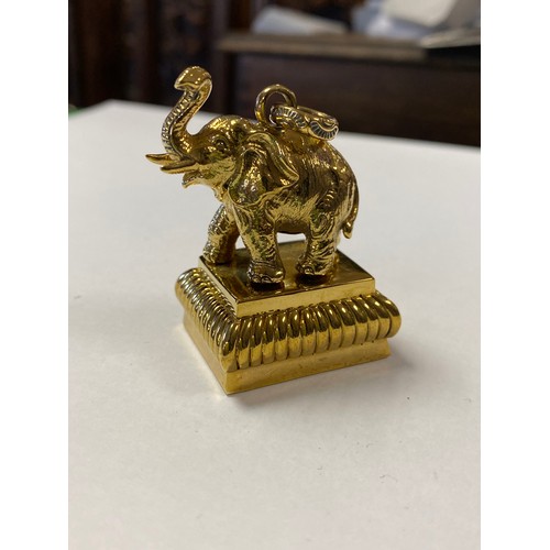 51 - A desk seal pendant, cast as an elephant, the base with a lion -