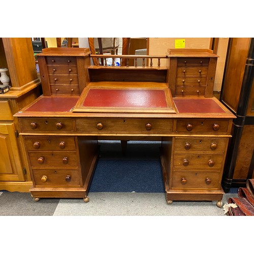 311 - A large late Victorian desk, the top with two sets of locking drawers and writing slope over an arra... 