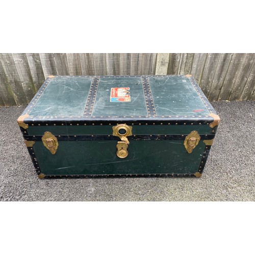 391 - A vintage metal bound trunk, with labels -