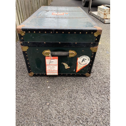 391 - A vintage metal bound trunk, with labels -