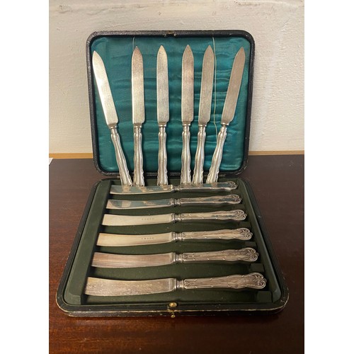 7 - A cased set of six silver handled knives and another loose set of silver handled knives -