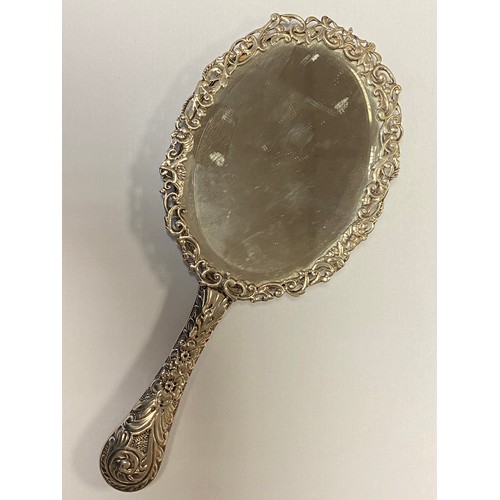 10 - A late Victorian silver dressing table mirror, London 1890, the frame with 'C' scrolls, flowers and ... 