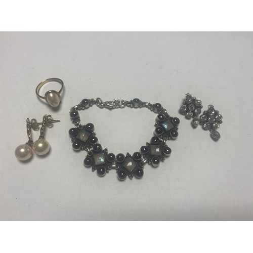 25 - A silver and gem set bracelet, a pair of silver earrings, gold plate on silver ring etc -