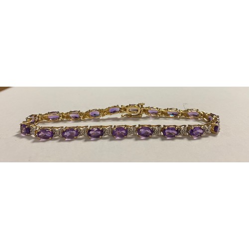 29 - A modern 10k gold and gem set bracelet, set with oval amethysts spaced by diamond points -