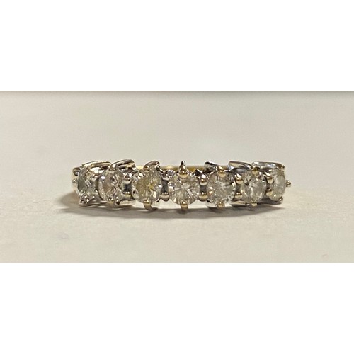 30 - A diamond half eternity ring, set with seven brilliant cut diamonds in 18ct gold -