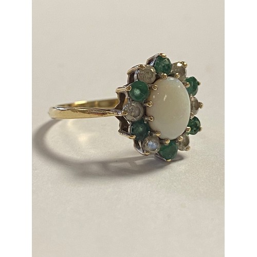 32 - An opal, emerald and CZ cluster ring, set in 9ct gold -