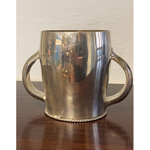 39 - An Edwardian silver two handled cup/coaster, London 1902, Wakeley & Wheeler -