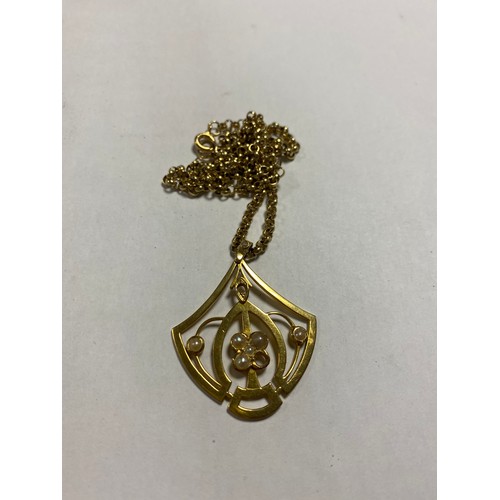 71 - A yellow metal openwork pendant, set with split pearls, (two deficient) to a 9ct gold belcher link c... 