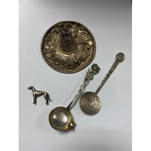 83 - A Mexican silver hat, together with a Mexican spoon, another spoon and a model greyhound (4) -