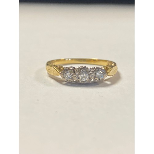 86 - A diamond three stone ring, the three diamonds illusion set in 18ct gold -