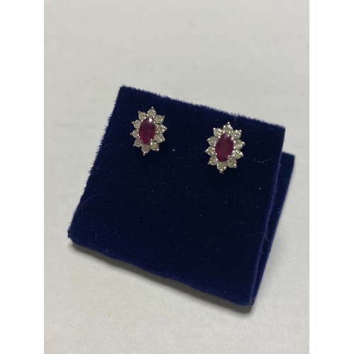 107 - A pair of ruby and diamond earrings, each set with a marquise ruby in a diamond border, set in 18ct ... 