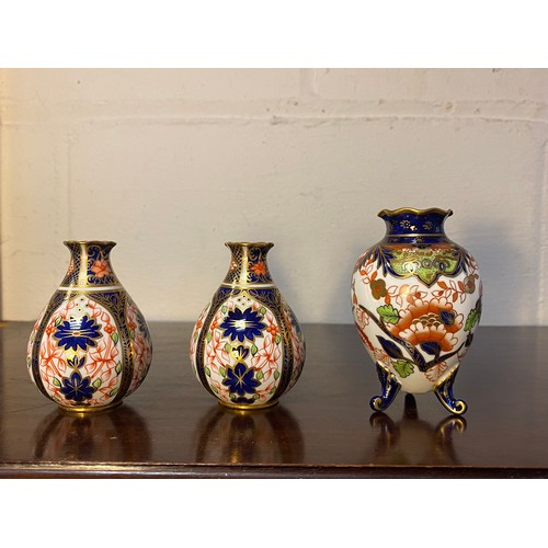 153 - A pair of Royal Crown Derby miniature vases, each with Imari decoration, and a similar vase raised o... 