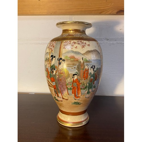 178 - A Japanese Satsuma vase, decorated with two panels of figures within floral decorated borders -