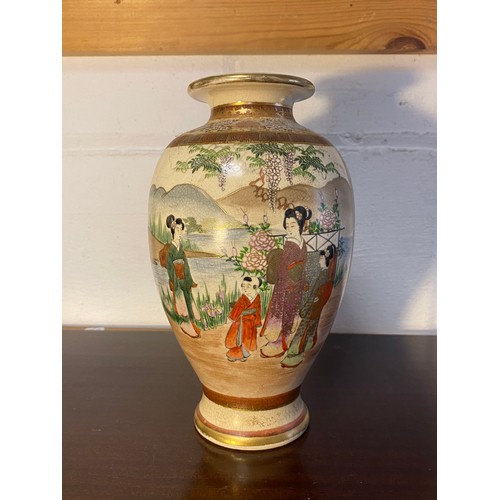 178 - A Japanese Satsuma vase, decorated with two panels of figures within floral decorated borders -