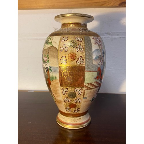 178 - A Japanese Satsuma vase, decorated with two panels of figures within floral decorated borders -