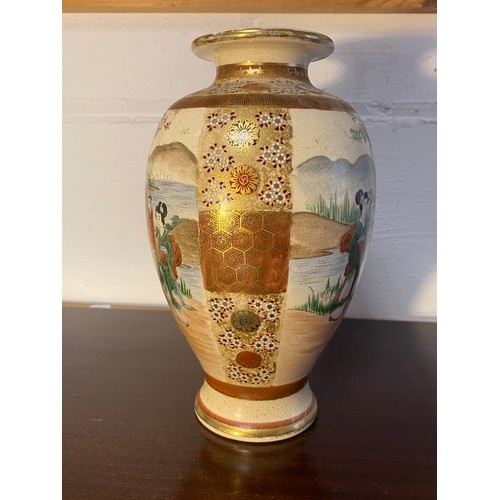 178 - A Japanese Satsuma vase, decorated with two panels of figures within floral decorated borders -