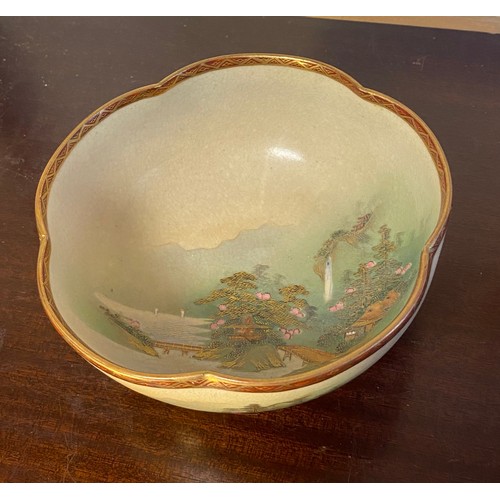 179 - A group of three Japanese Satsuma bowls, the largest decorated with a landscape scene to the centre ... 