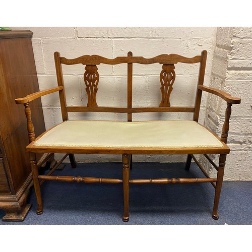 407 - An oak framed two seater chair back settee, with pierced splat back, padded seat and turned supports... 