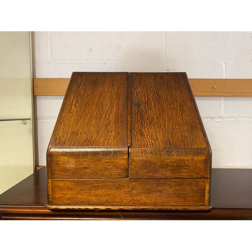 409 - An early 20th century oak table top stationery cabinet, with two doors opening to reveal a fitted in... 