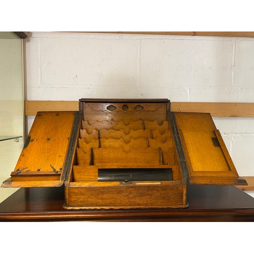 409 - An early 20th century oak table top stationery cabinet, with two doors opening to reveal a fitted in... 