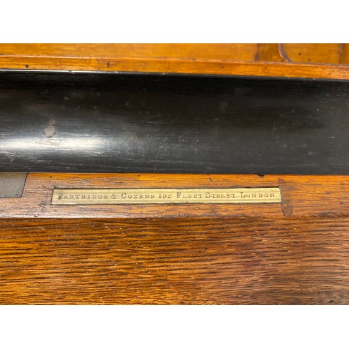 409 - An early 20th century oak table top stationery cabinet, with two doors opening to reveal a fitted in... 