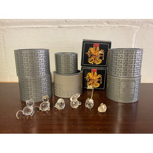 69 - A group of six Swarovski crystals animals, all boxed, and a pair of gold plated candlesticks -