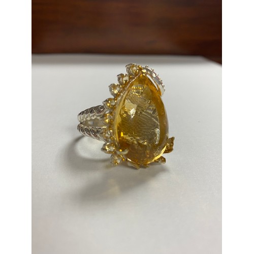 8 - A modern silver and gem set ring, set with a large pear shaped citrine with pink and yellow stone ac... 