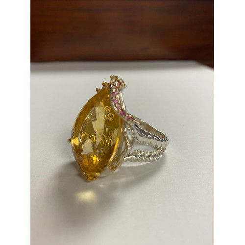 8 - A modern silver and gem set ring, set with a large pear shaped citrine with pink and yellow stone ac... 