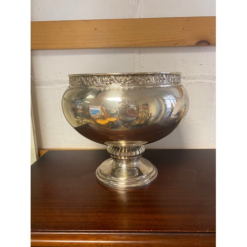 27 - A large silver pedestal bowl, Birmingham 1937, with flower and leaf border, lobed support and steppe... 