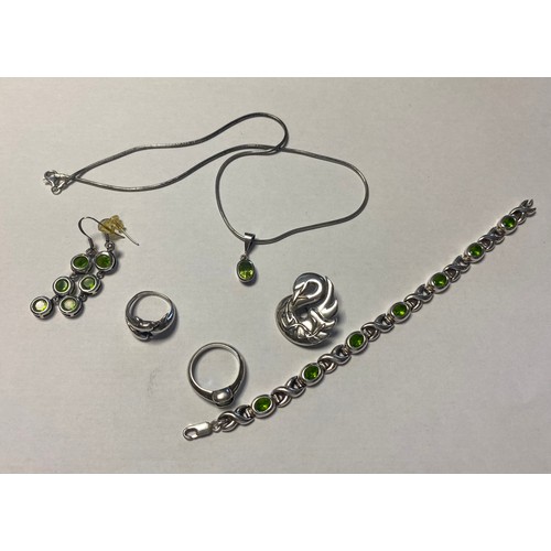 38 - A modern silver and gem set bracelet, necklace and ear-pendant suite, each piece collet set with ova... 