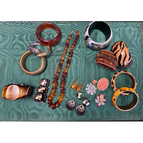 39 - An amber necklace and a pair of ear-pendants, various bangles, brooches etc -