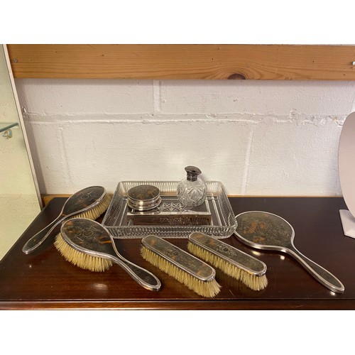 58 - A matched silver and tortoiseshell dressing table set, comprising two pairs of brushes, hand mirror,... 