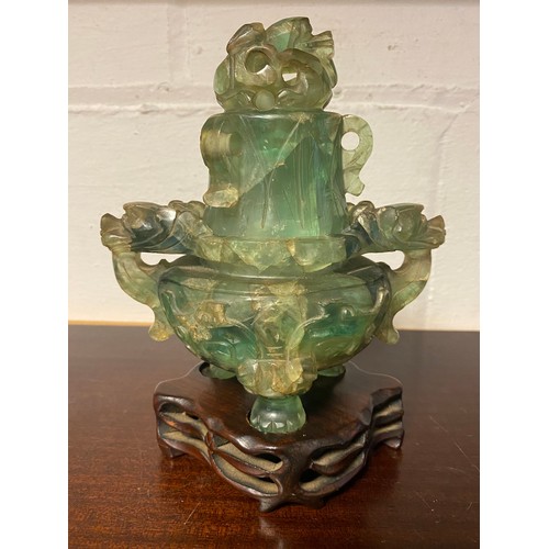 61 - A Chinese fluorite censer and cover, with carved and pierced decoration, on carved hardwood stand -