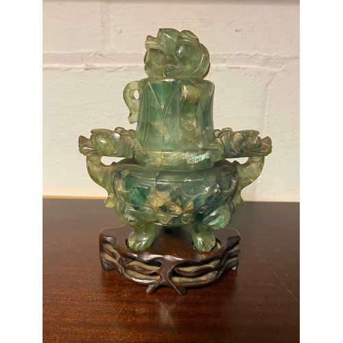 61 - A Chinese fluorite censer and cover, with carved and pierced decoration, on carved hardwood stand -