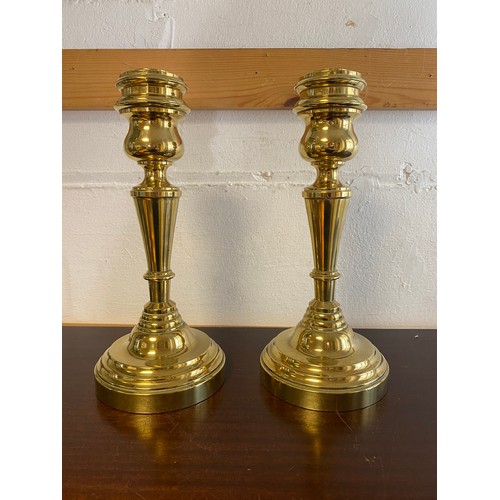 168 - A pair of heavy brass candlesticks -