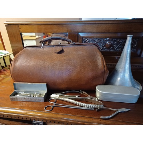 180 - A vintage leather doctors bag and a small quantity of medical equipment -