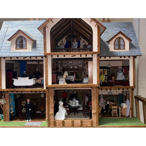 128 - A large three storey dolls house, designed as a mock Tudor house called Romen, with nine rooms, toge... 