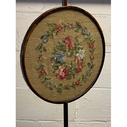 268 - A 19th century pole screen, with adjustable circular embroidered screen, over trefoil base and bun f... 