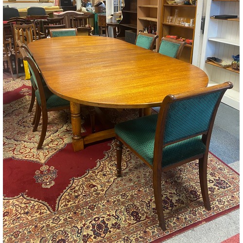 277 - An oak extending dining table, from Brights of Nettlebed, the rounded top with two additional leaves... 